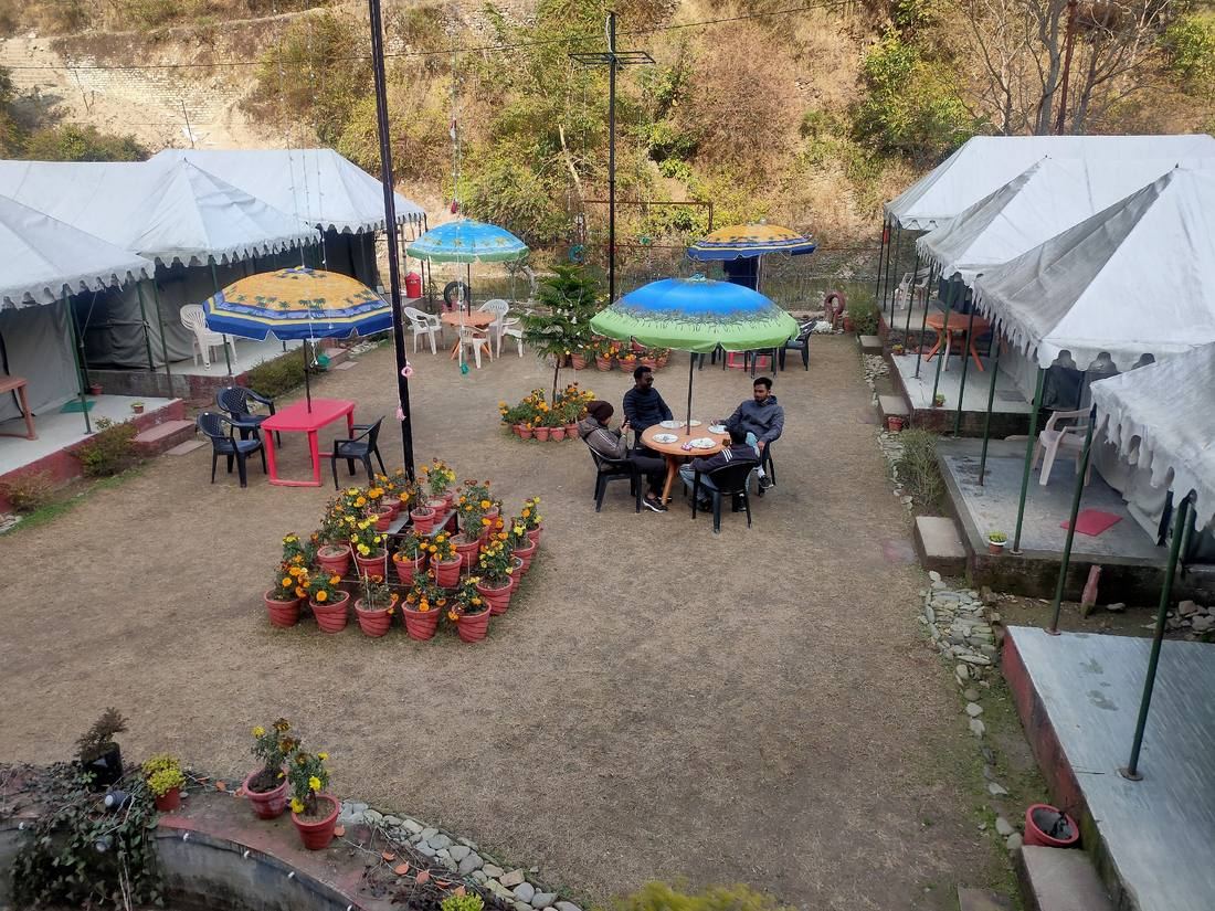 Riverside dining area under umbrellas