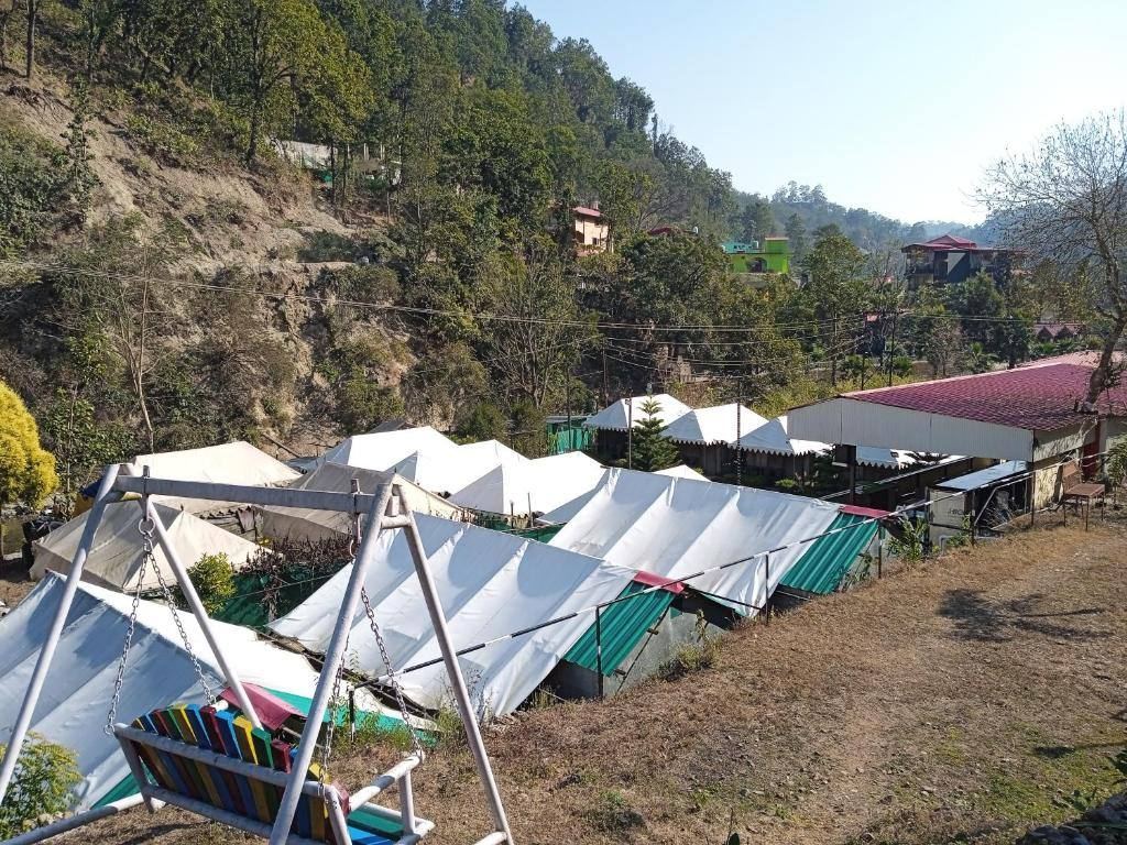Tents nestled into the wooded hillside