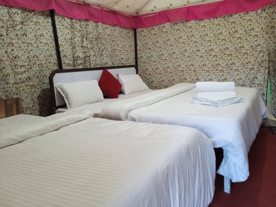 Twin beds inside a camp tent